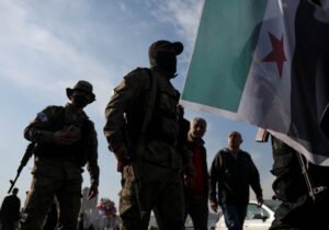 Climate Vs Conflict: Which Is The Bigger Global Risk? 1 People Gather During A Celebration Called By Hayat Tahrir Al-Sham (Hts), In Damascus